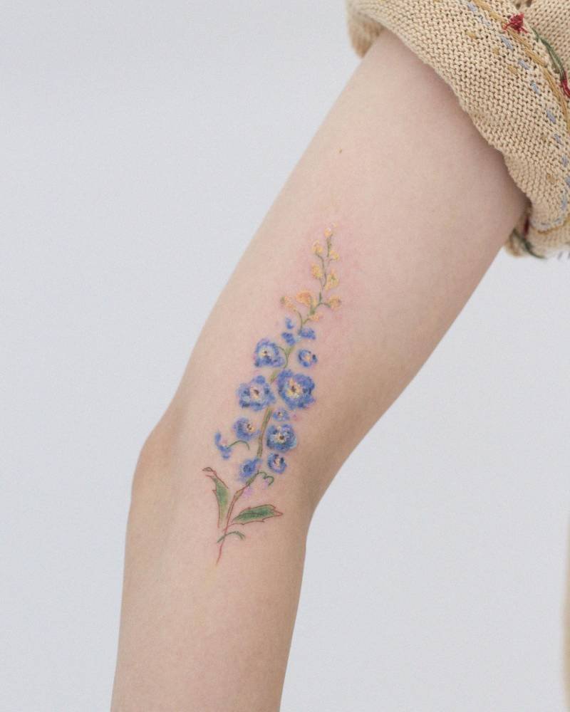 Delicate blue larkspur tattoo