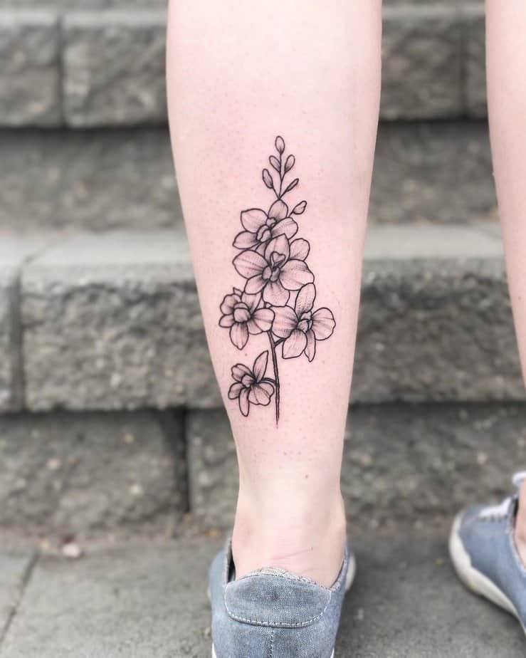 Linework larkspur calf tattoo