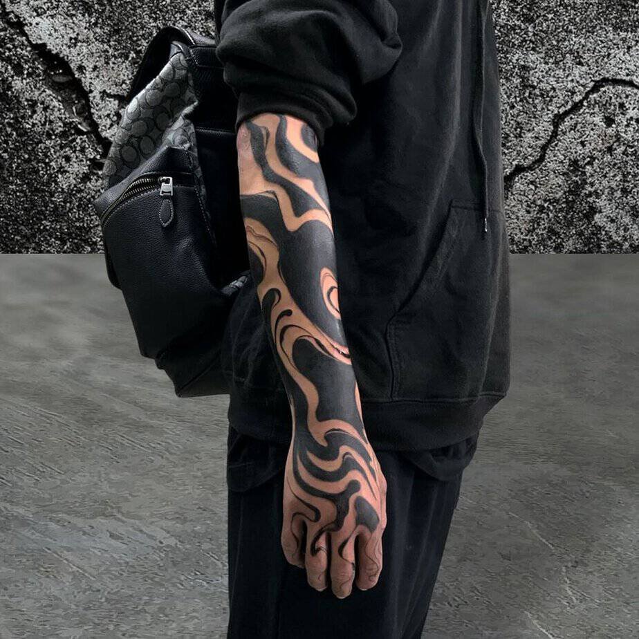 Abstract suminagashi flowing from forearm into hand