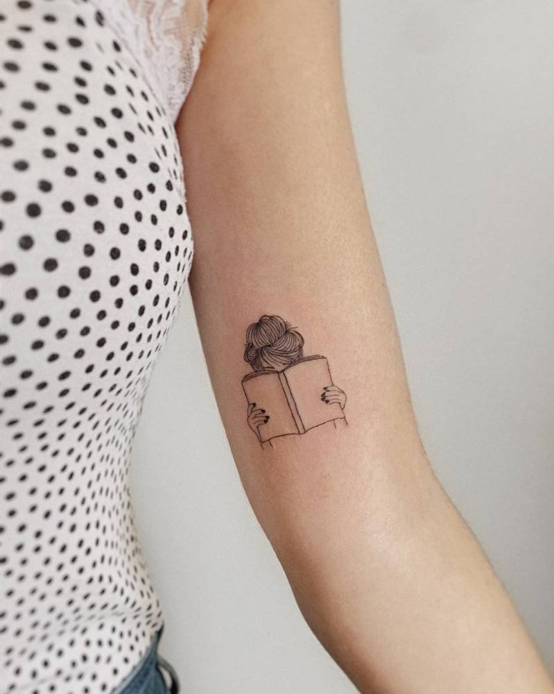 Girl hiding behind a book