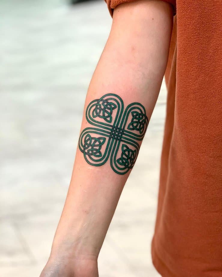 Green Celtic knot forearm tattoo