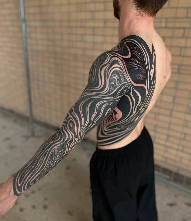 Half back-and-arm suminagashi extending across shoulder and down arm