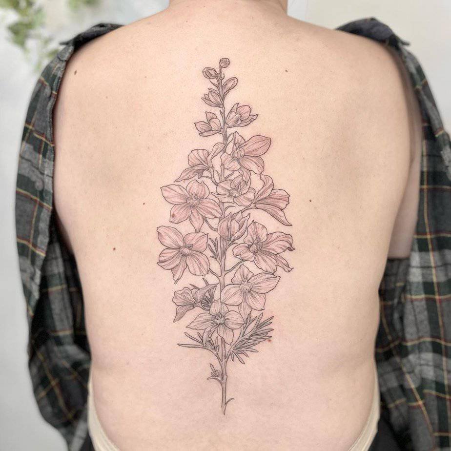 Large larkspur tattoo across the back