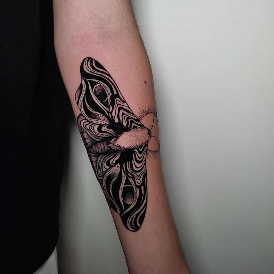 Butterfly tattoo with suminagashi-patterned wings blending nature and art