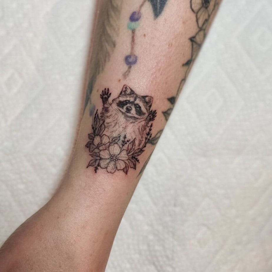 Raccoon tattoo with flowers