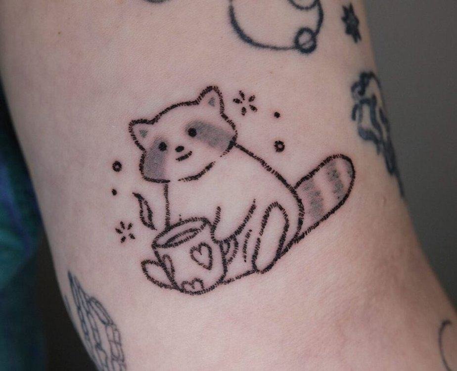 Cozy raccoon tattoo