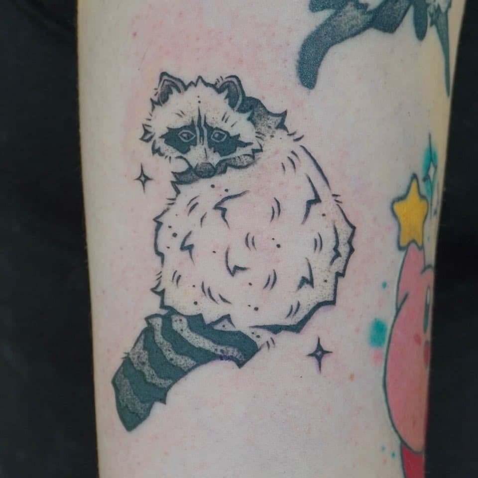 Cartoon raccoon tattoo