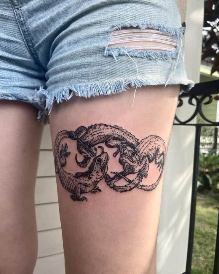 Entwined lizards in black ink