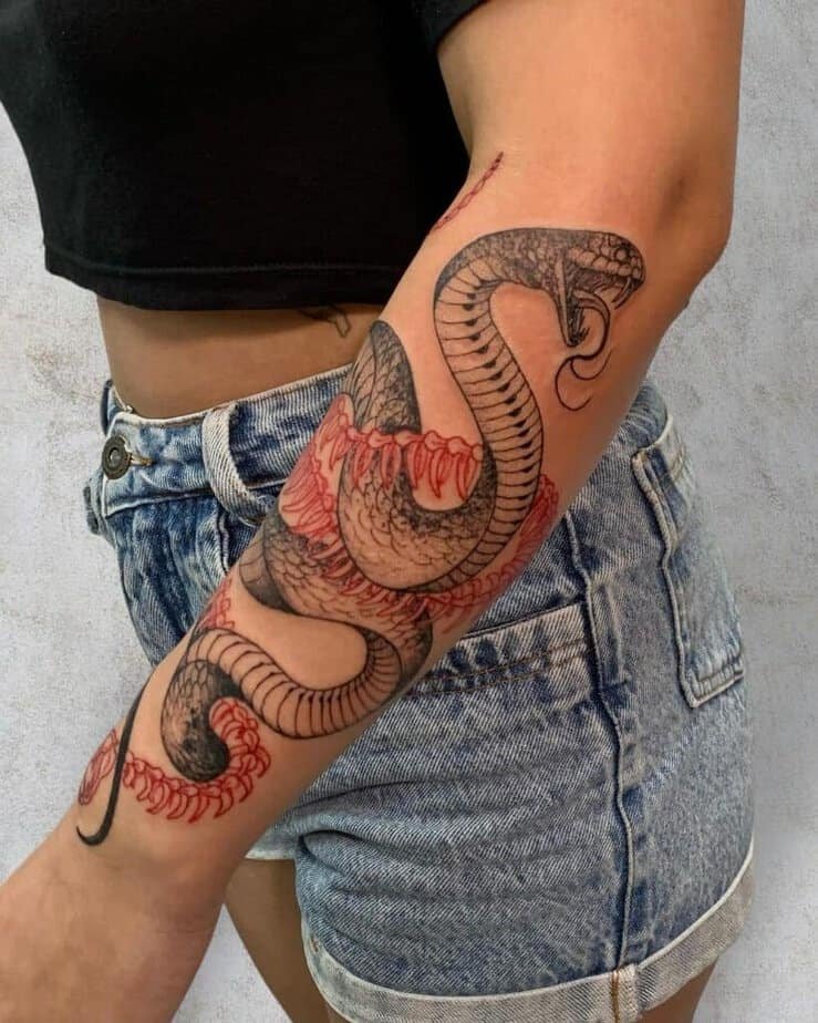 10. A black and red ink cobra tattoo