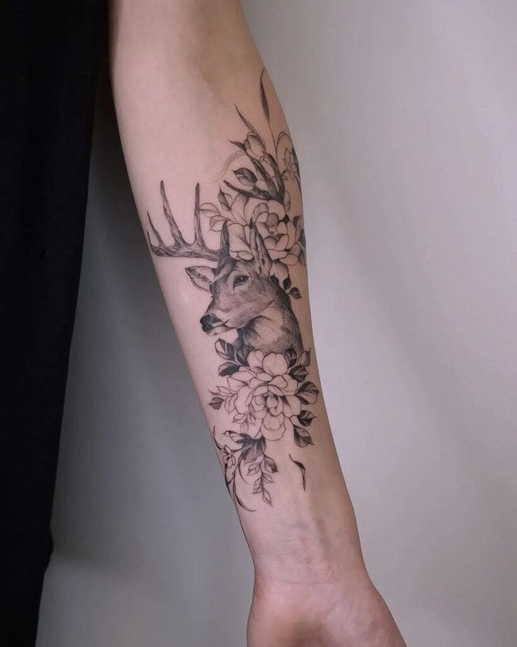 1. A tattoo of a deer surrounded by flowers