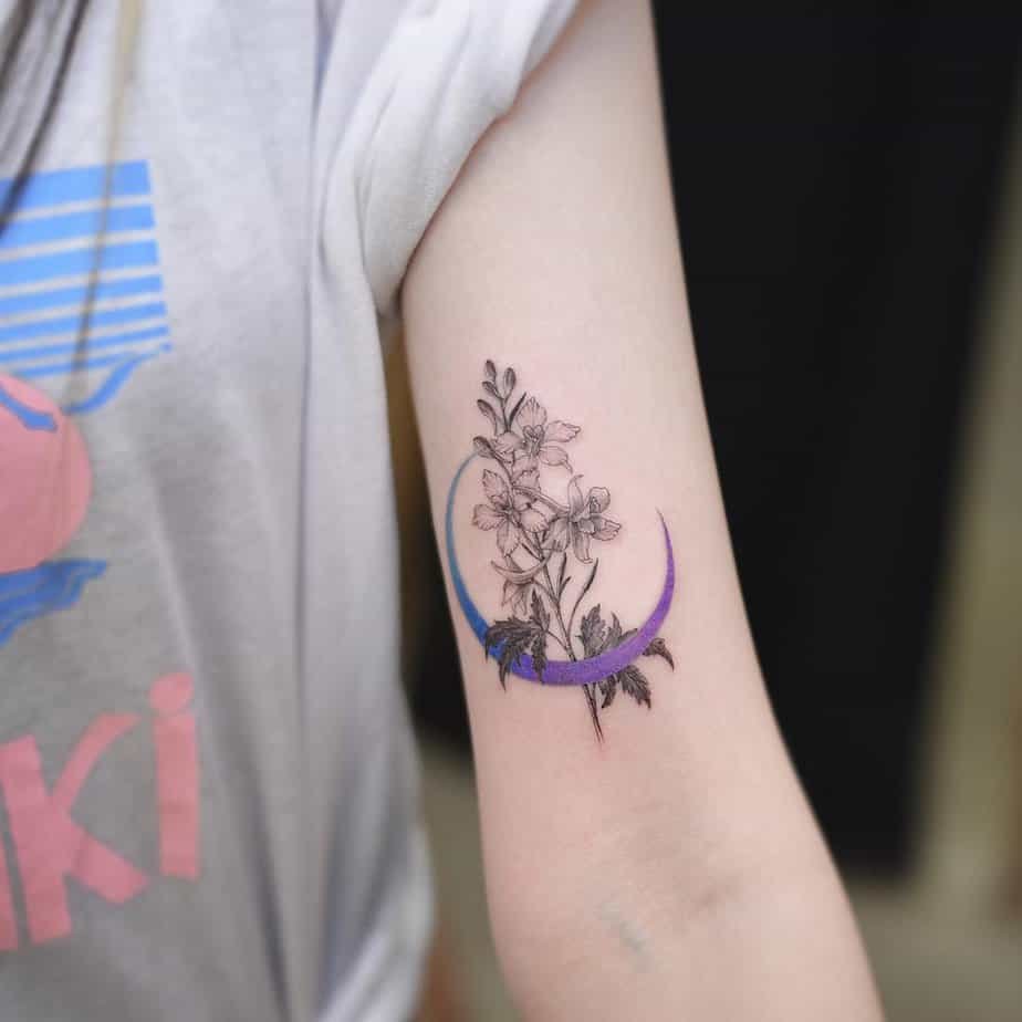 Larkspur with a crescent moon tattoo