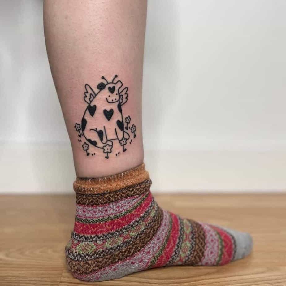 13. A cow tattoo on the ankle