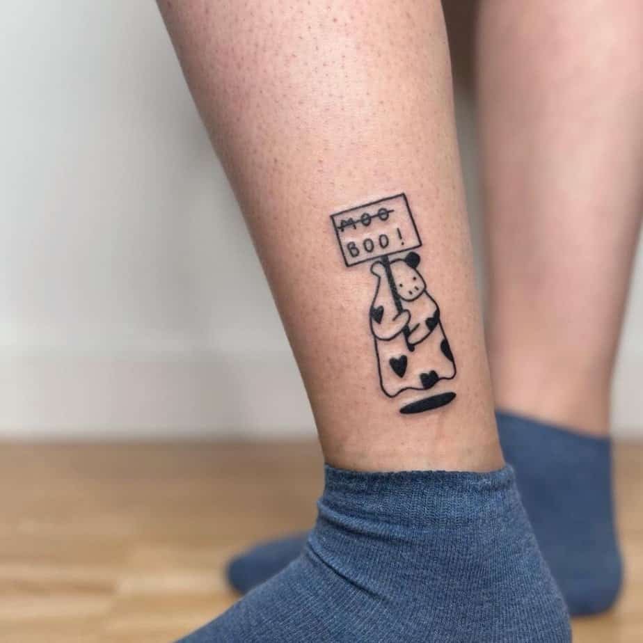 14. A tattoo of a cow with heart spots