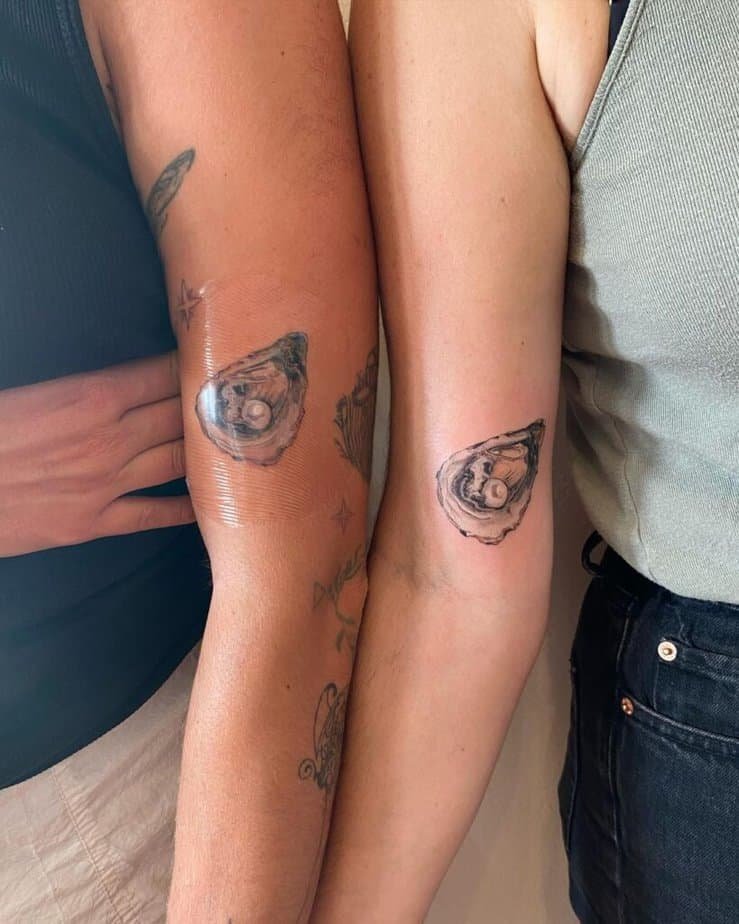 17. Matching oyster pearl tattoos on the bicep
