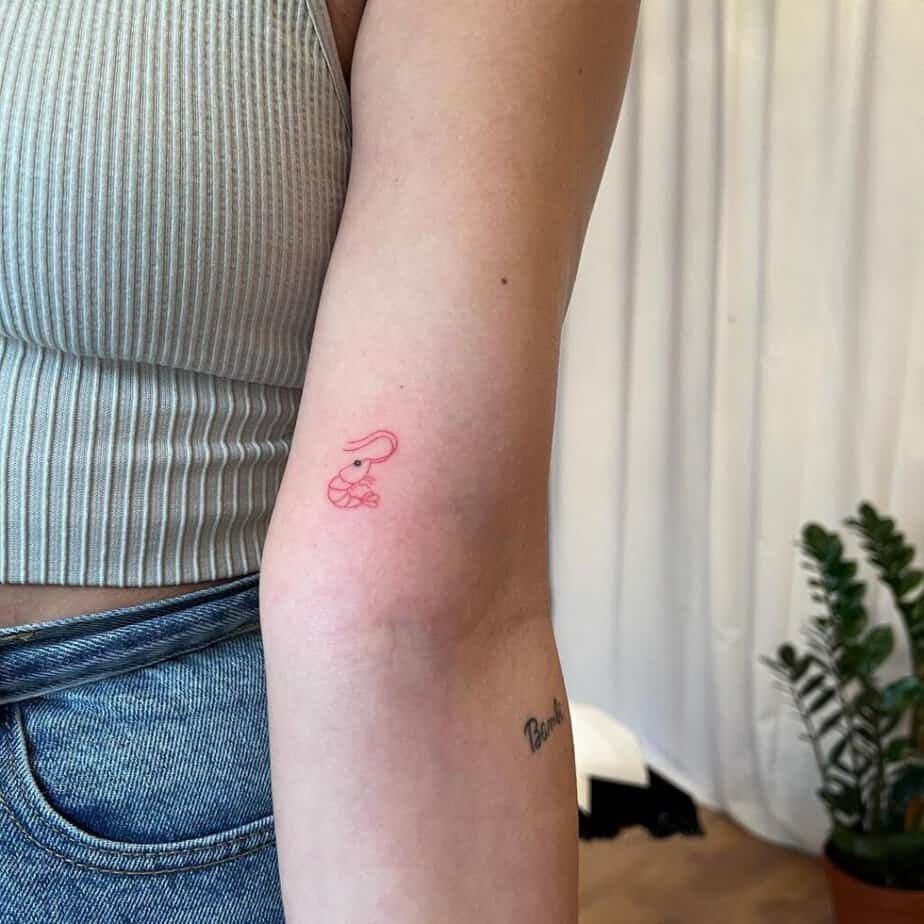 10. A tiny red shrimp tattoo on the bicep