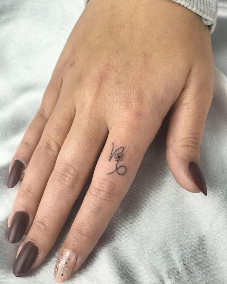 4. A Capricorn symbol tattoo on the finger