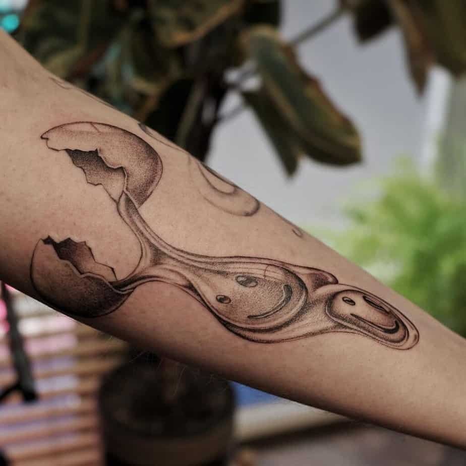 12. A cracked egg tattoo on the forearm
