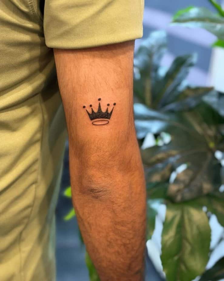 11. A tiny crown tattoo on the back of the arm