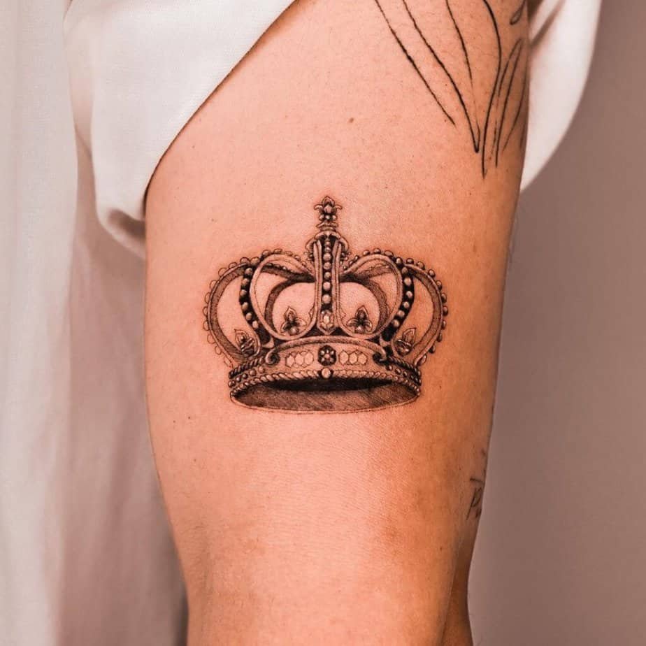 2. A detailed crown tattoo on the upper arm