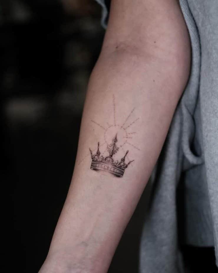 22. A detailed crown tattoo with a dotwork sun