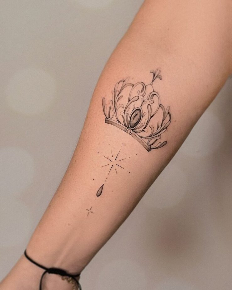 24. A fine-line crown tattoo with ornaments