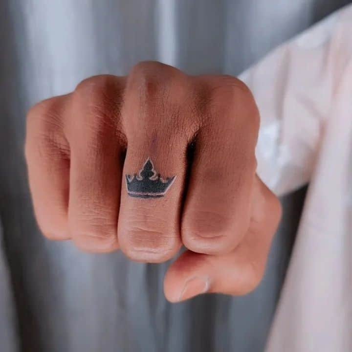 25. A crown tattoo on the finger