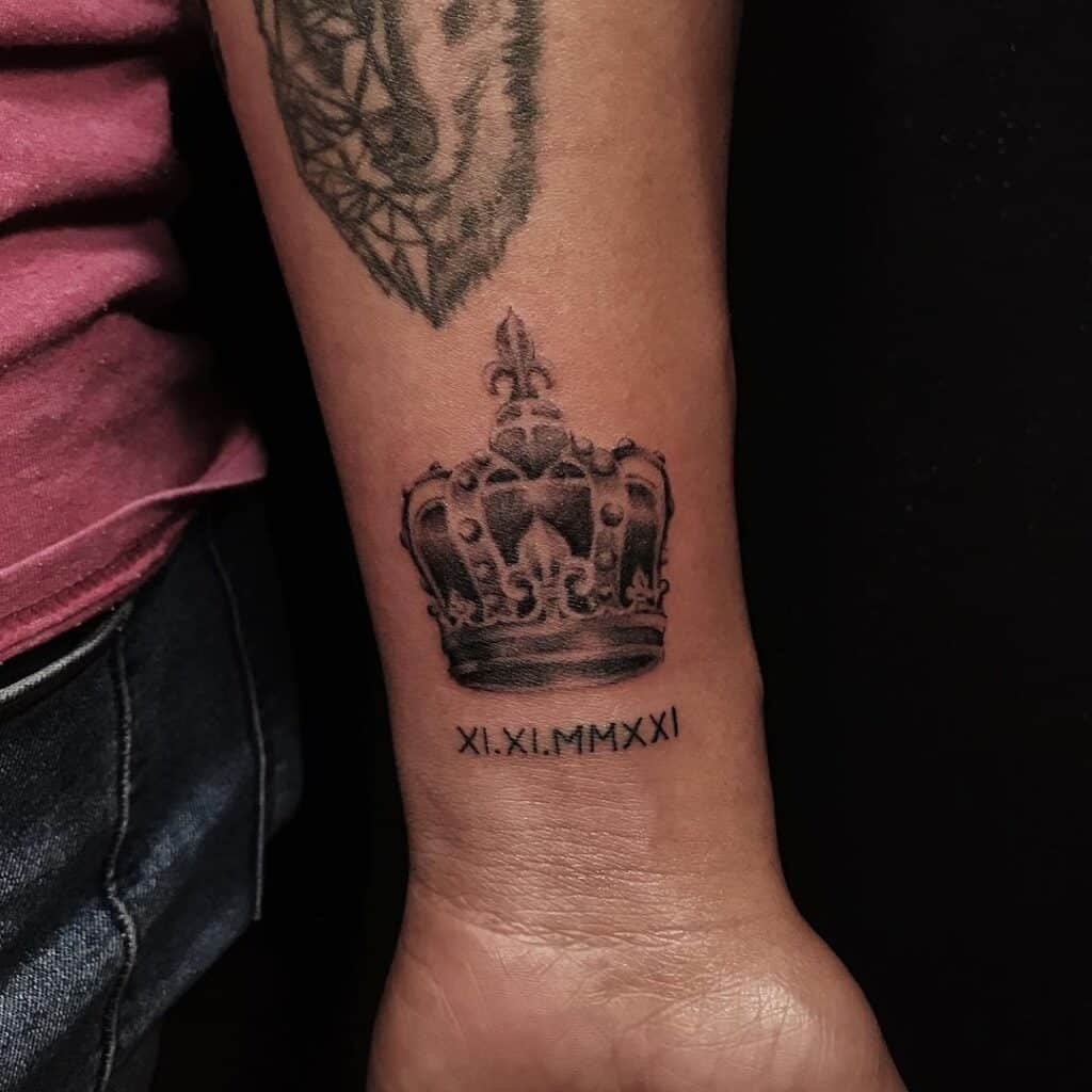 7. A tattoo of a crown with Roman numerals on the wrist