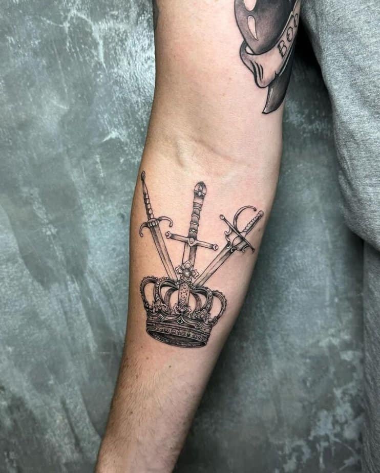 8. A tattoo of a crown with three swords on the forearm