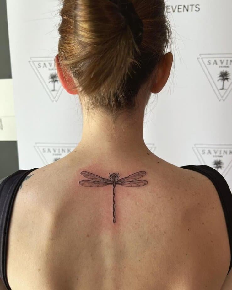 6. A tattoo of a dragonfly on the back