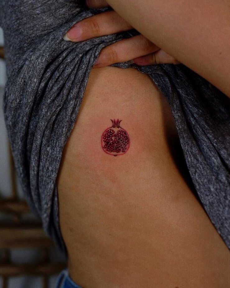20. A pomegranate tattoo on the rib