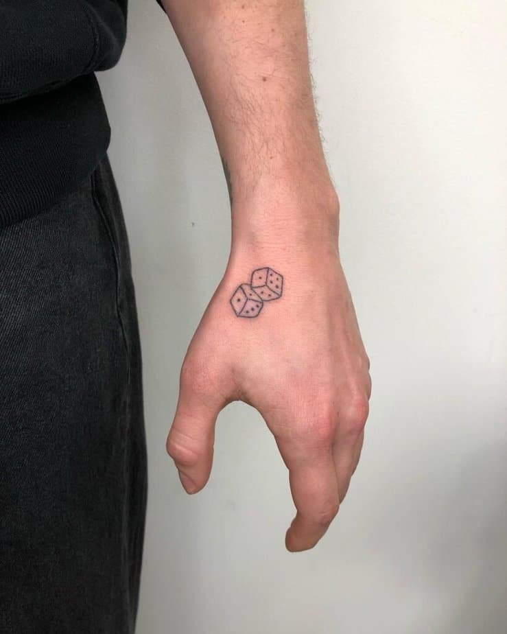 1. Tiny dice tattoo on the hand 