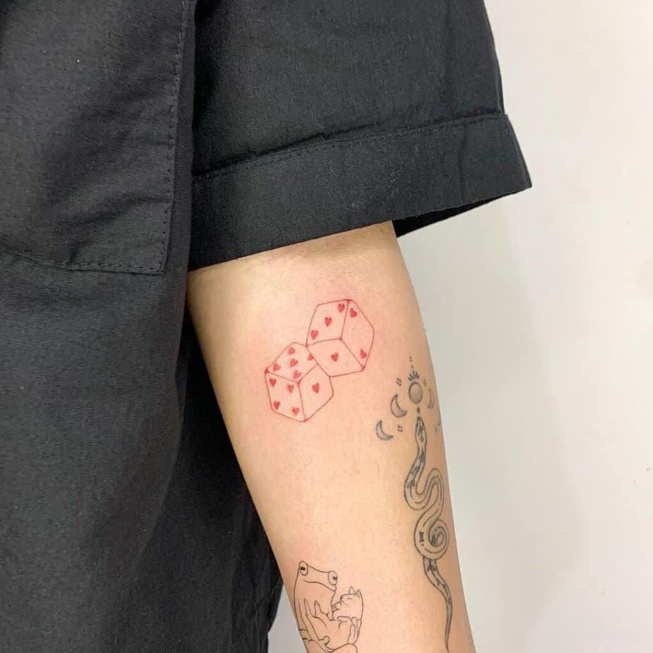 3. Red dice tattoo on the forearm