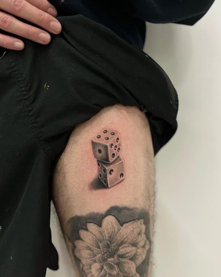 4. Dice tattoo on the thigh