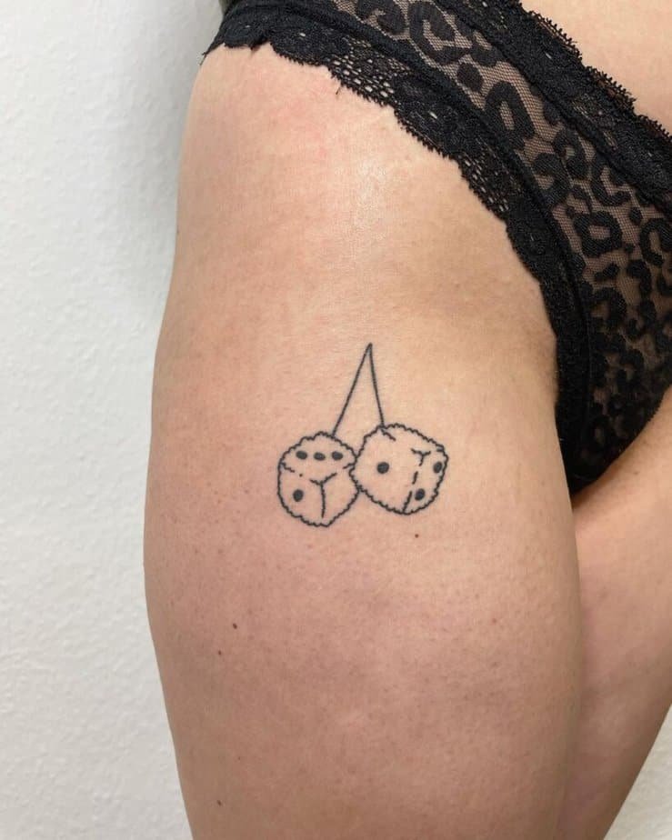 11. A hip tattoo of fluffy dice