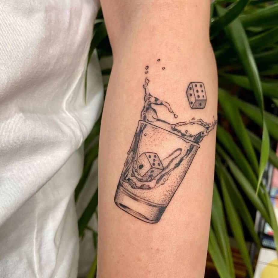 21. A forearm tattoo of dice ice 