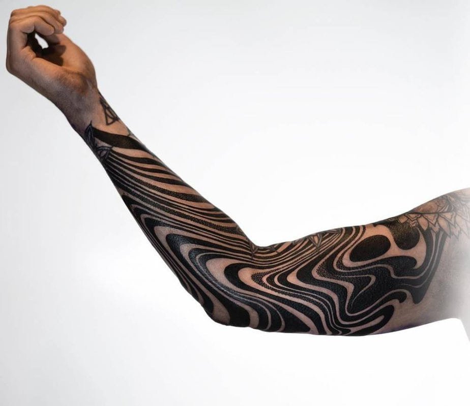 Curved ink flow poured across the forearm