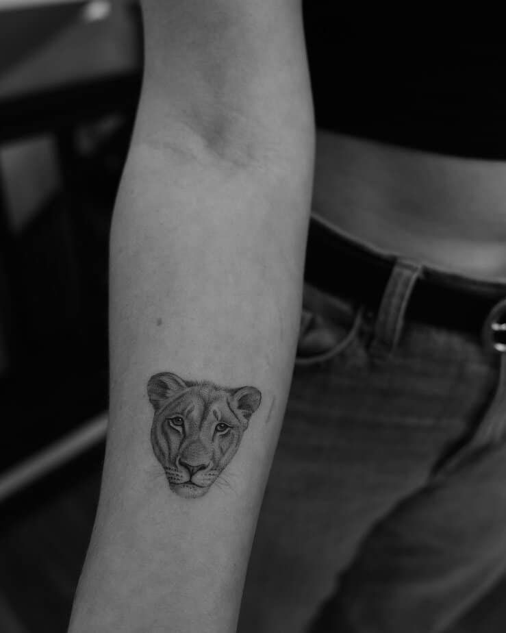 Tiny lioness face on forearm