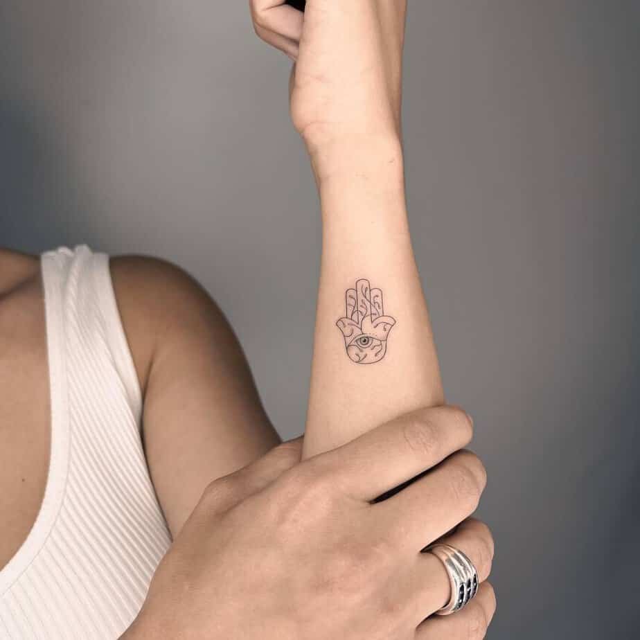 Tiny hamsa on the forearm