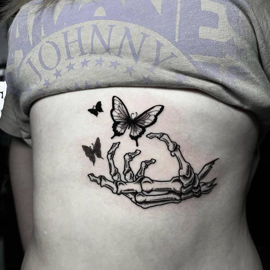 Skeleton hand releasing butterflies