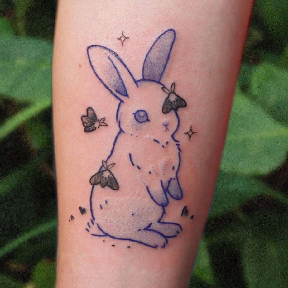 Blue bunny and moth forearm tattoo