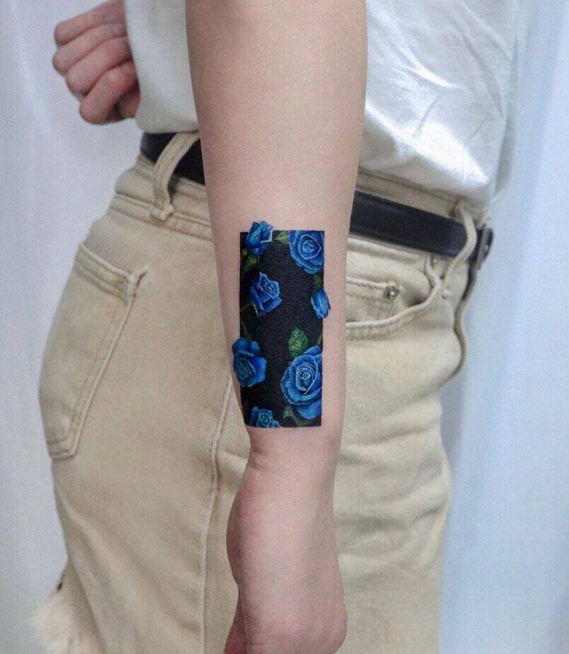 Blue roses covering a black rectangle as a cover-up