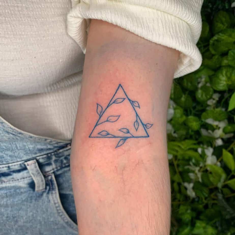 Blue triangle with leaves tattoo