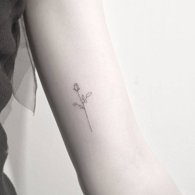 Cute tiny rose tattoo on upper arm