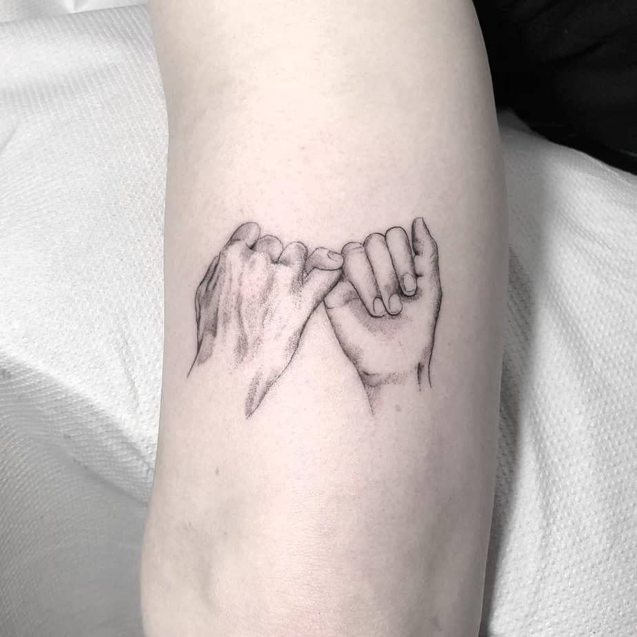 Realistic pinky promise tattoo