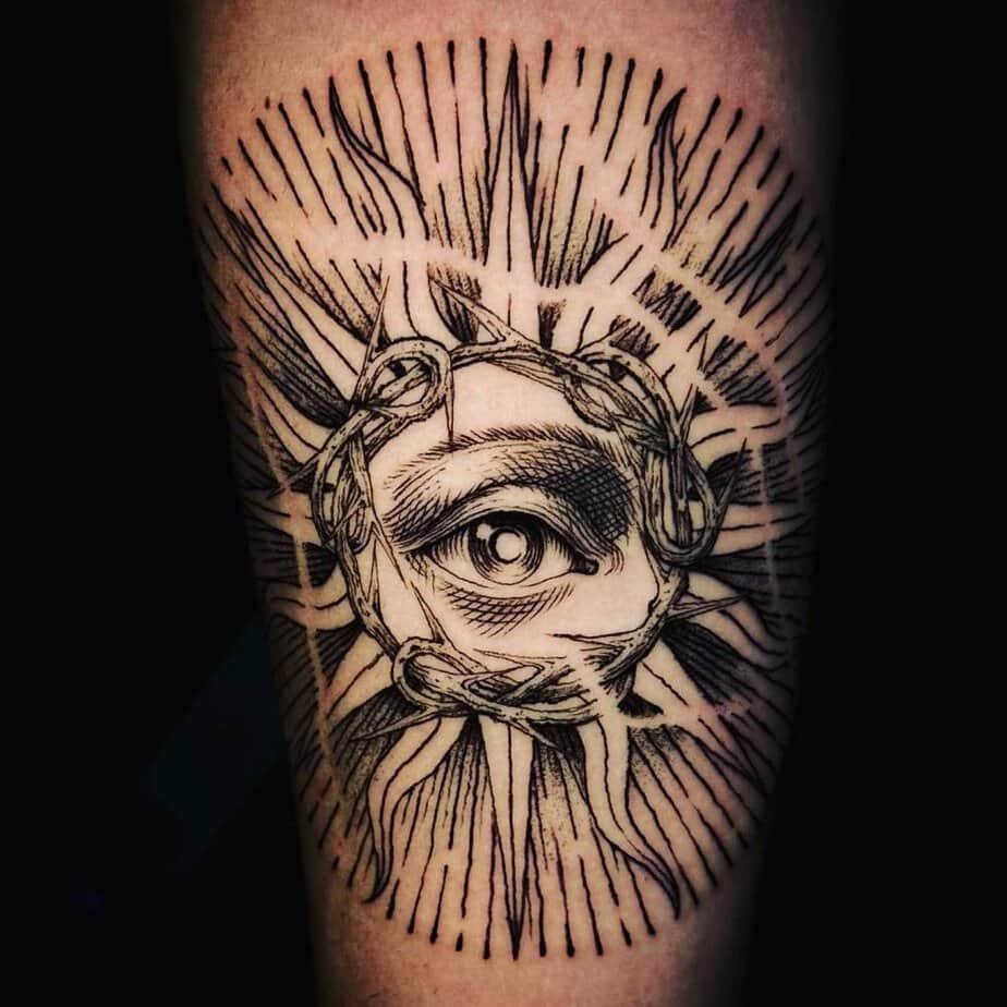 Sun with an eye engraving tattoo