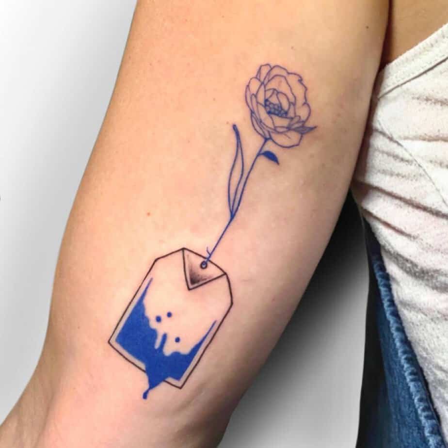 Blue rose with a teabag hanging from its stem