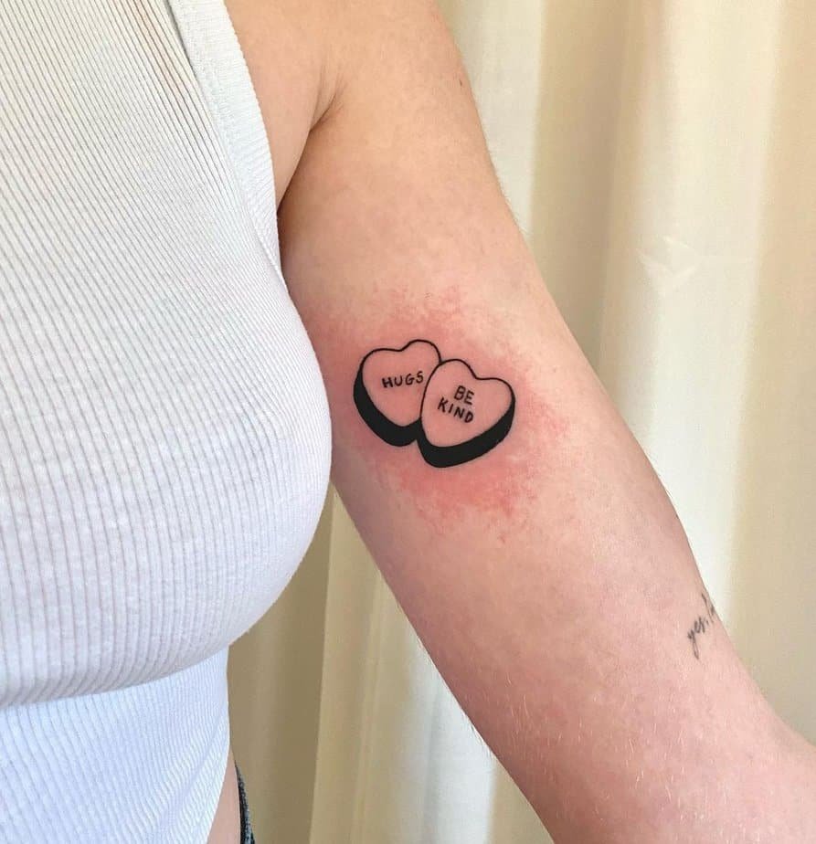 2. A “hugs” and “be kind” tattoo
