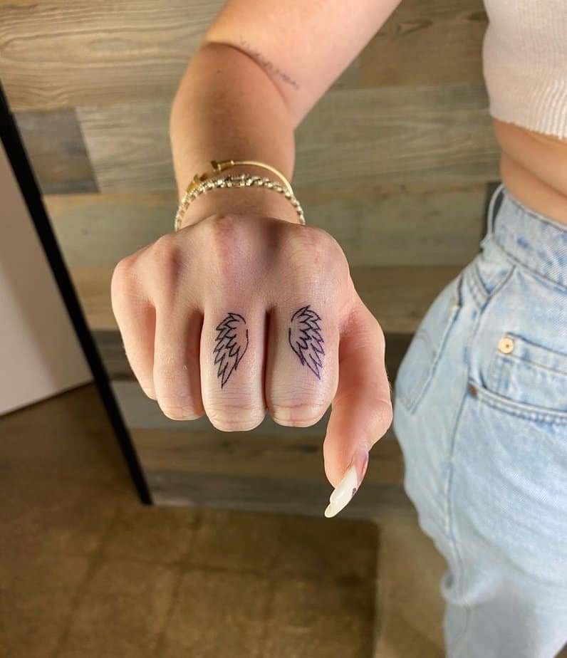 9. A tattoo of wings on your fingers
