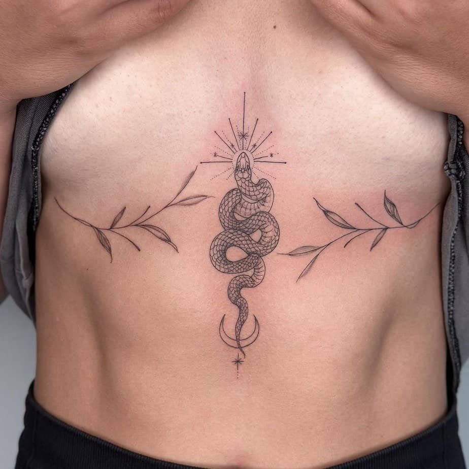 A maximalist snake sternum tattoo
